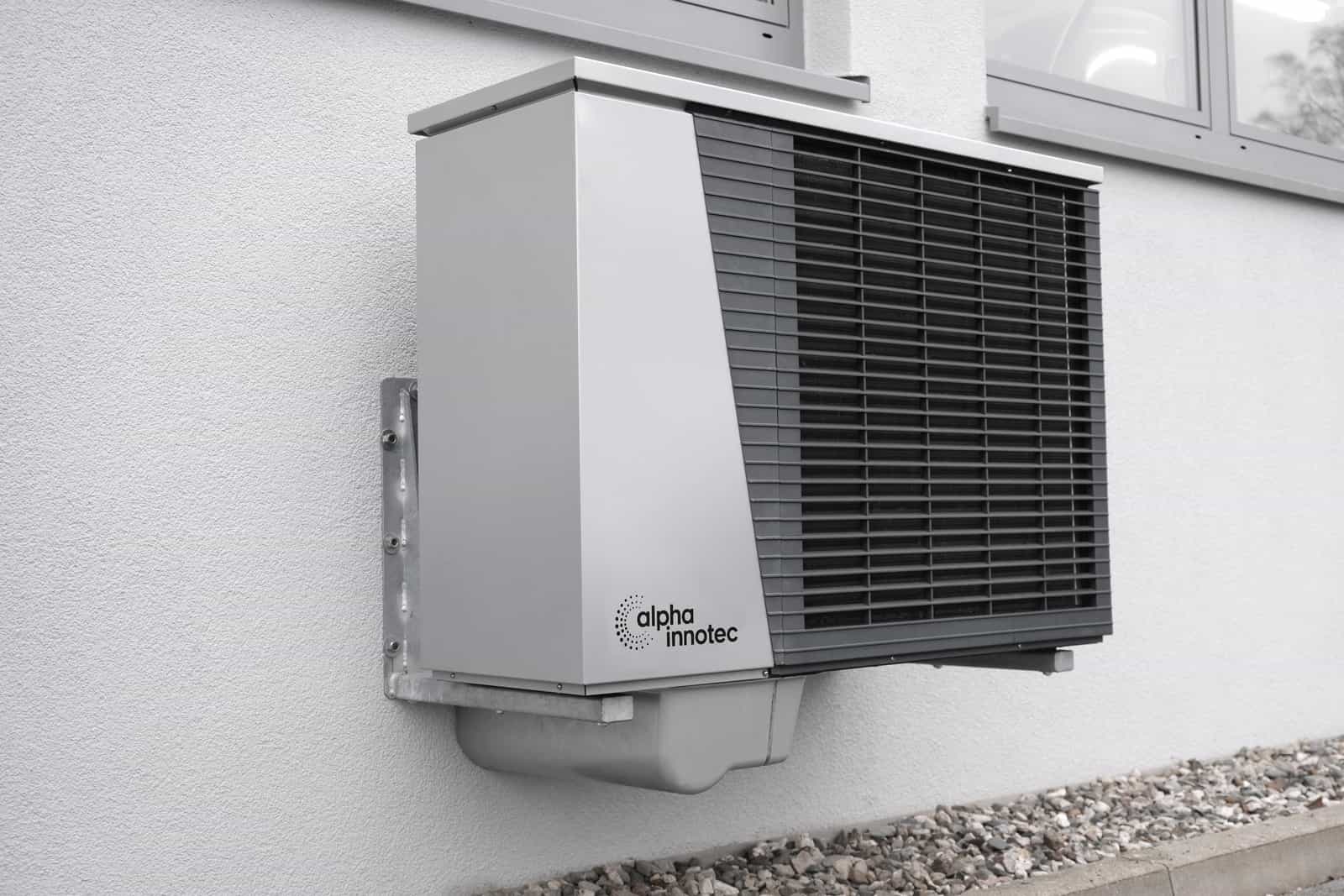 An outdoor heat pump unit beside a house wall