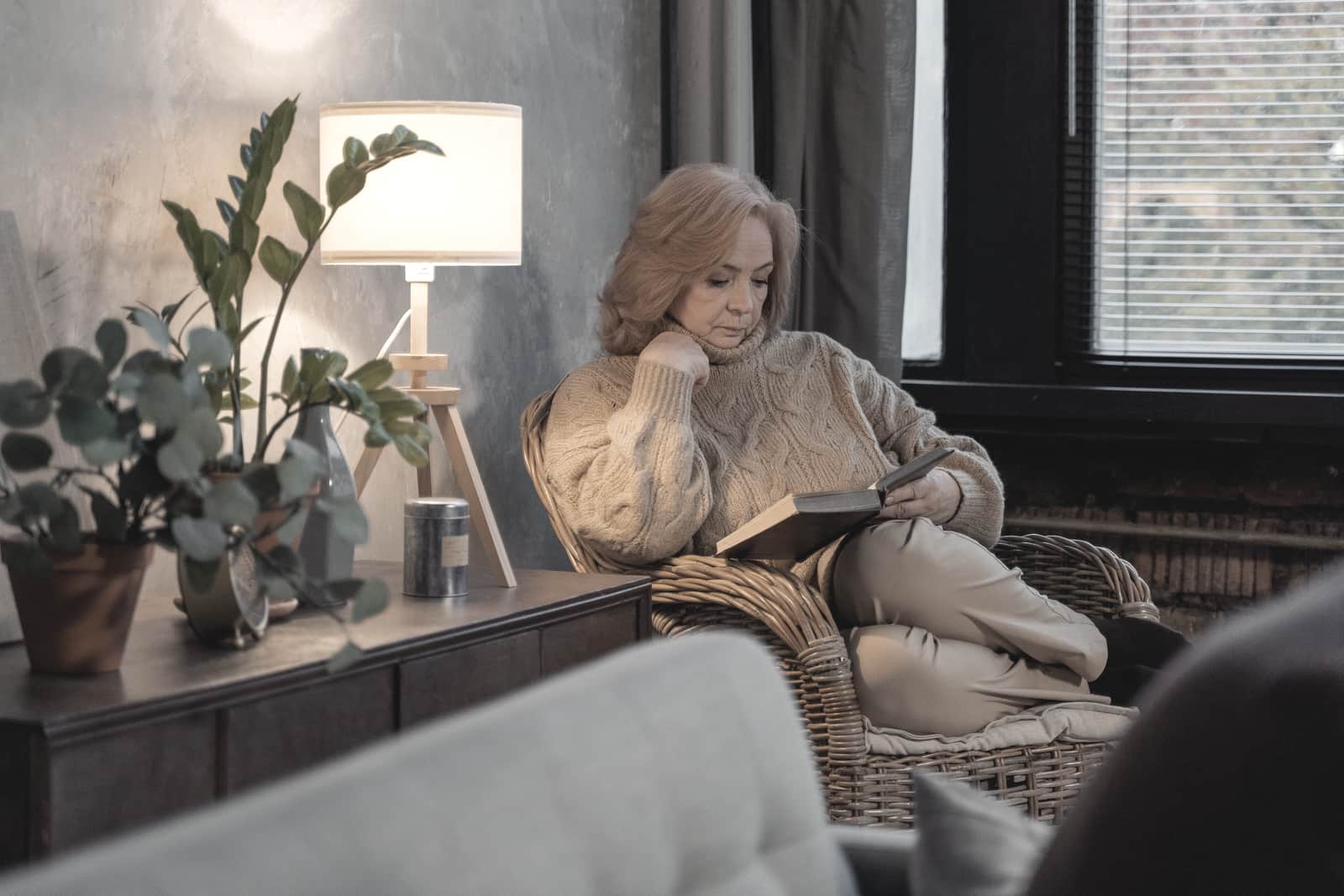 A quiet reading corner with an armchair beside a bright window
