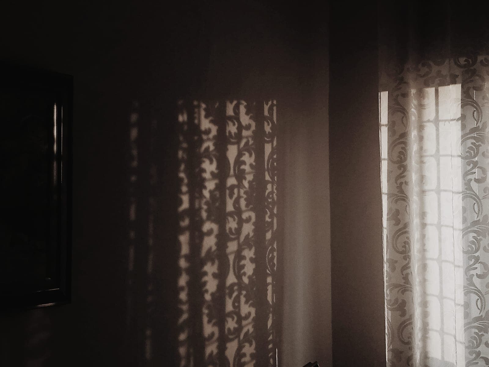 Warm sunlight falling through a window onto a pale interior wall